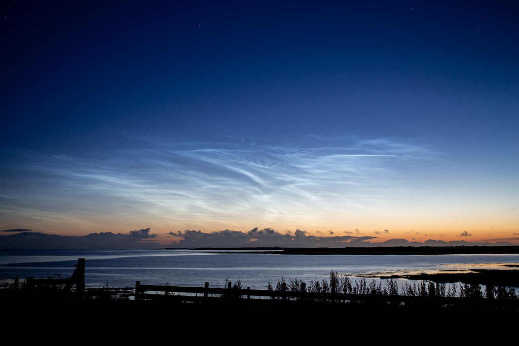 bay of water with sunrise sky and clouds