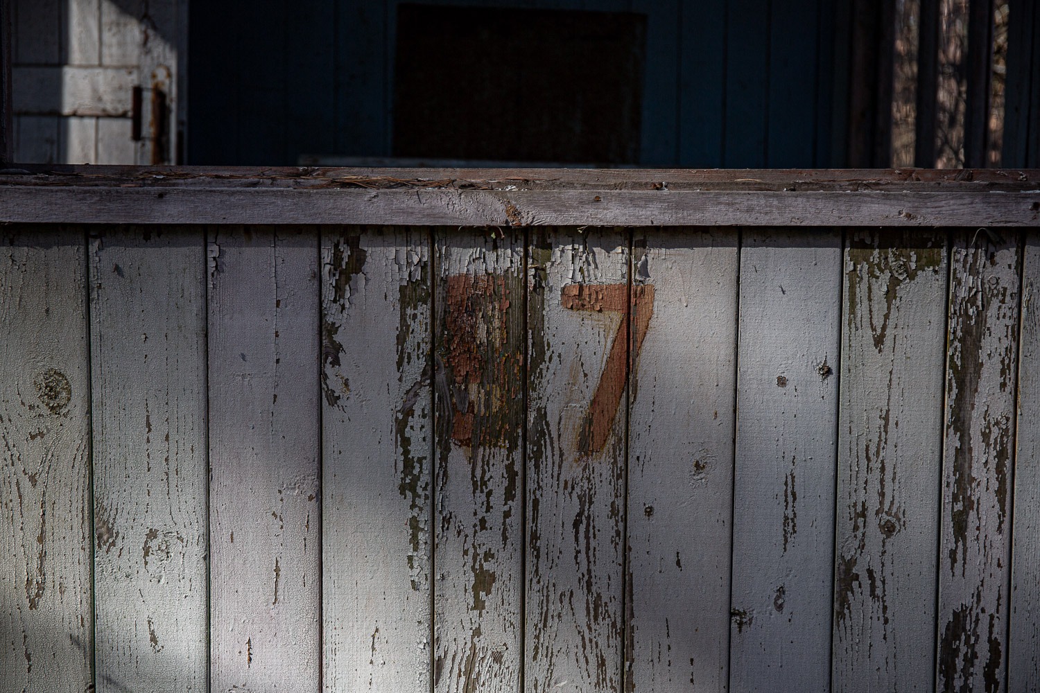 Painted number 87 on a wooden door